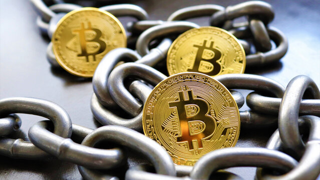 Conceptual financial photography of gold Bitcoin cryptocurrency tokens entangled with industrial steel chains representing blockchain security b 14