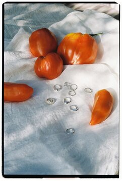 A still life with tomates, rings, jewellery
