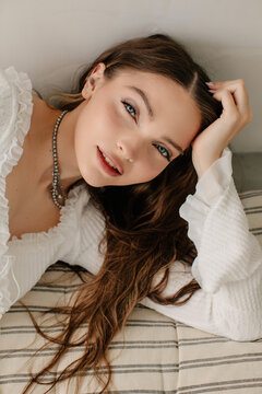 Pretty model in relaxed pose looking at camera 