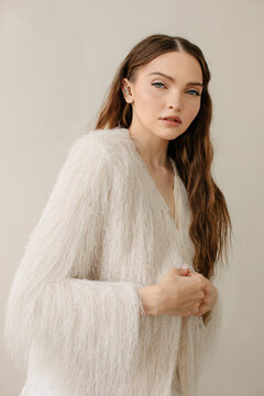 Fashion portrait of pretty woman in white