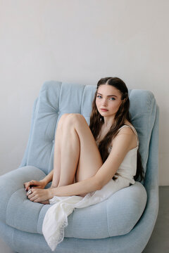 Woman sitting on arm chair