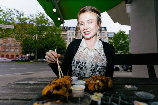 Woman Eating Sushi Outdoors Berlin