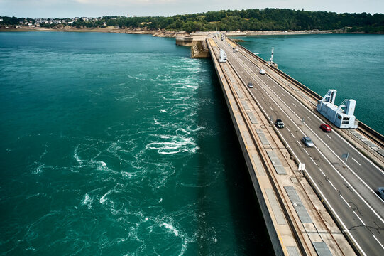 Renewable energy transition - tidal power flows under roadway barrage