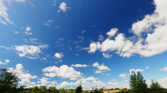 Summer Sky With Fast Moving White Clouds Above Low Horizon, Sunny Weather Timelapse, Blue Sky and Cloudscape Nature Background