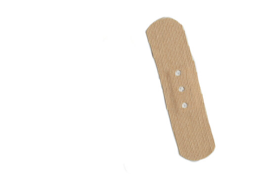 Adhesive bandage strip isolated on clean white background, macro shot for medical concept space.