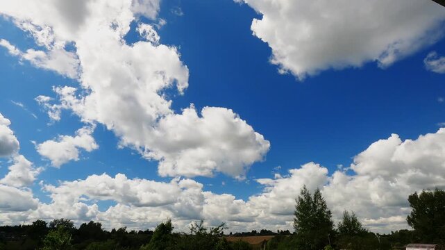 Sunlit White Clouds Rapidly Moving Across Clear Summer Sky, Beautiful Natural Weather Timelapse Background