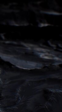 Water flows over smooth rocks as the day transitions to night. The scene captures the interaction of light and dark in a natural setting. This moment shows the beauty of nature.