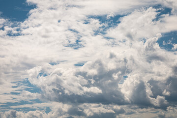 Soft clouds drift across a bright blue sky © Romain