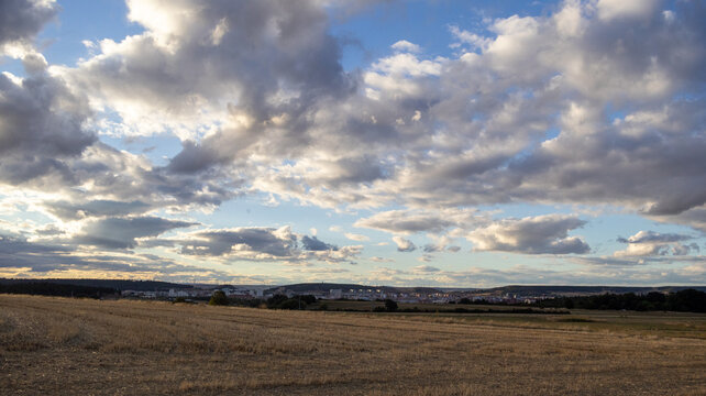 Cielo nublado con rayos de sol sobre el horizonte urbano