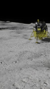 A lunar lander sits on the moons surface. The lander is yellow and has various parts. The surrounding area is rocky and barren with shadows in the background.