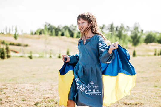 Ukraines Independence Flag Day. Constitution day. Ukrainian child girl with yellow and blue flag of Ukraine in field. flag symbols of Ukraine. Kyiv, Kiev day