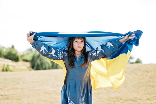 Ukraines Independence Flag Day. Constitution day. Ukrainian child girl with yellow and blue flag of Ukraine in field. flag symbols of Ukraine. Kyiv, Kiev day
