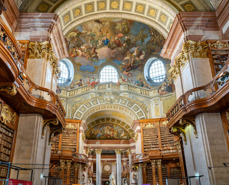 Magnificent ceiling paintings and ornate interior of the historic State Hall at the Austrian National Library in Vienna.