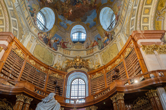 Magnificent ceiling paintings and ornate interior of the historic State Hall at the Austrian National Library in Vienna.