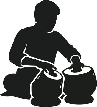 Silhouette of a man playing tabla.