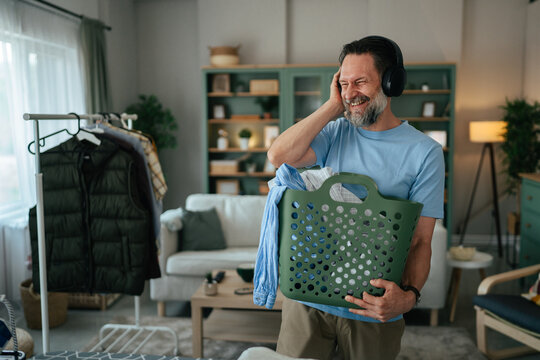 Man enjoying music while doing housework chores