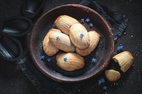 Traditional Madeleine cookies baked inside fluted tins.