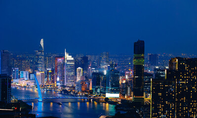 Fototapeta premium Aerial view Night landscape of coastline with skyscrapers of Ho chi minh or Saigon city in business center of Vietnam