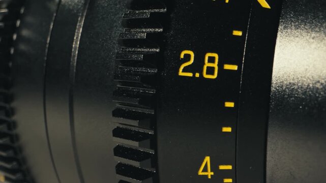 Camera operator working with cinema macro lens on film set behind the scenes production