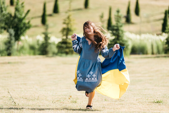 Ukraines Independence Flag Day. Constitution day. Ukrainian child girl with yellow and blue flag of Ukraine in field. flag symbols of Ukraine. Kyiv, Kiev day