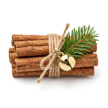 Ultra-realistic festive bundle of several dry cinnamon sticks tied tightly with natural twine, accompanied by a polished brass jingle bell and a small green pine branch