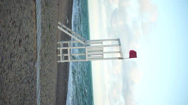 Lifeguard Chair Beach Red Flag Warning - A lifeguard chair with a red flag warning on the beach.