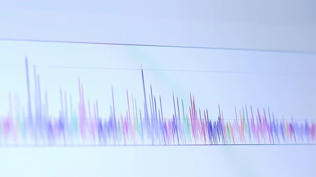 Colorful vertical waveform-like lines fluctuate along a horizontal baseline on a pale blue-white background, with shifting purple, cyan, pink, and green spikes forming an abstract data display