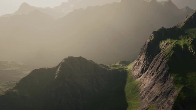 Mountains stand tall as sunlight shines on their peaks. Green valleys lay between the rocks. The scene shows a mix of light and shadow on the landscape.