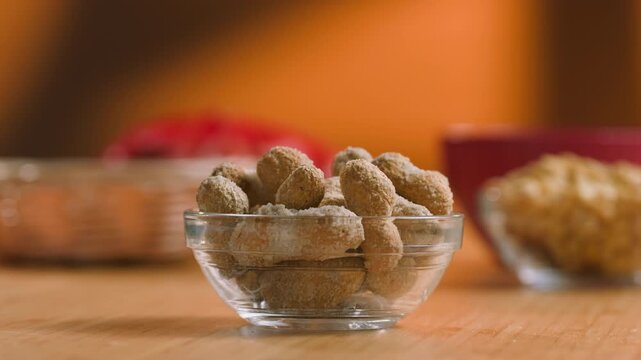 Peanuts in Salted Shell Man Cracking and Eating Salty Nuts as a Classic Bar Snack at Cafe