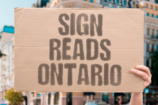 "Sign reads Ontario" Canada posts counter-name on lake shore. SIGN. ONTARIO. CANADA. RETAKE. SHORE.