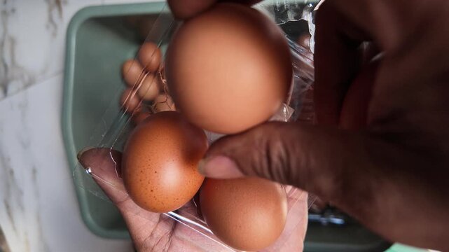  Hands Packing Omega-3 Eggs into mini box  Packaging