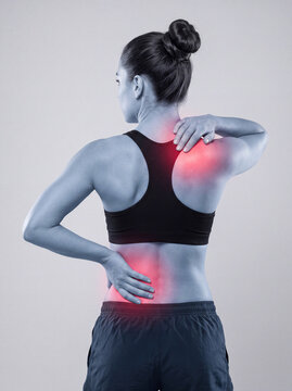 Rear View of Athletic Woman Experiencing Shoulder and Low Back Pain