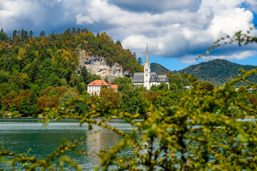 Fototapeta premium Panorama of the Bled lake, Blejsko Jezero, the Saint Martin church, or Cerkev Svetog Martina. it's a catholic church and monument of Slovenia.