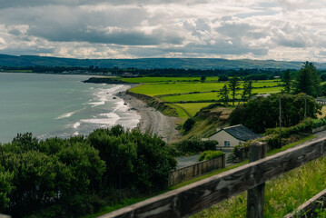 Obraz premium Coastal bay landscape in County Waterford, Ireland, near Dungarvan and the scenic Waterford Greenway cycling route - County Waterford, Ireland - 31 August 2026.