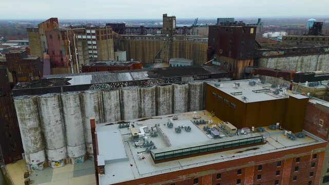 Cinematic Drone Flyover Of Silo City Grain Elevators Along Buffalo River Under Overcast Sky In Buffalo New York
