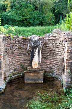 Headless marble statue in a brick alcove at the Sanctuary of Isis in Dion.