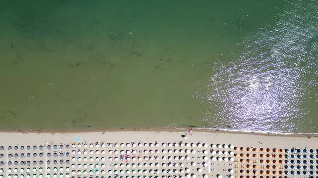 Aerial drone view of historic Porto Canale Leonardesco harbor lined with colorful boats, traditional houses and Adriatic coastline in Cesenatico, Emilia-Romagna, Italy