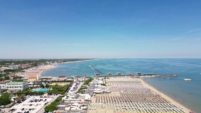 Aerial drone view of historic Porto Canale Leonardesco harbor lined with colorful boats, traditional houses and Adriatic coastline in Cesenatico, Emilia-Romagna, Italy