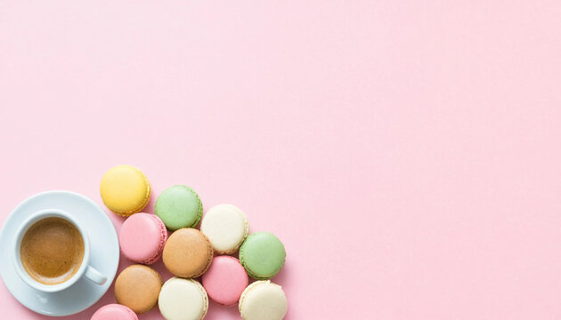French macaron sweet cookies with espresso coffee cup on pastel background, cafe menu header with copy space.