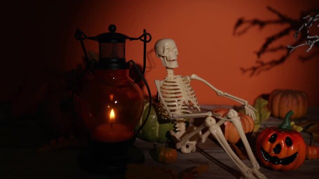 Camera glide past candle lantern and seated skeleton for Halloween decor, spooky party backdrops and cozy autumn interiors