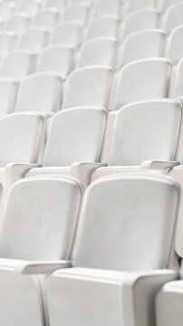 Rows of sculptural white seats fill a minimal theatre-inspired modern interior. Soft daylight highlights geometric rhythm, creating a refined and calm atmosphere.