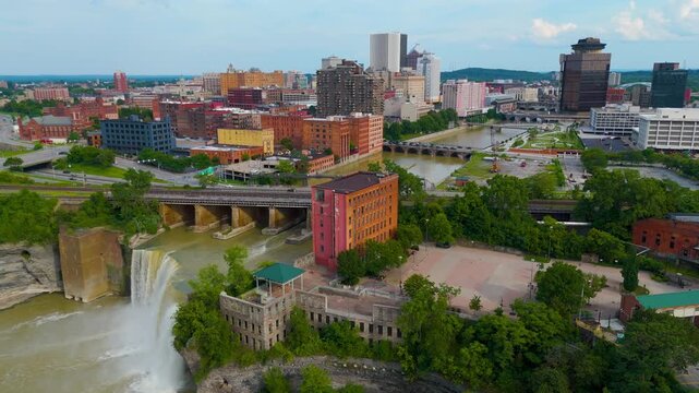Cinematic Drone Pan Over Downtown Rochester Skyline Featuring High Falls, Genesee River, And Historic Bridges