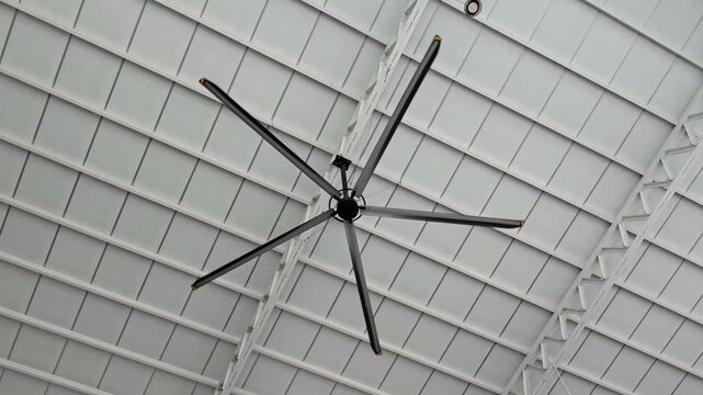 HVL ceiling fan blades spinning overhead for indoor cooling, Air Circulation System, Facility Appliance, Airflow Ventilation Machinery