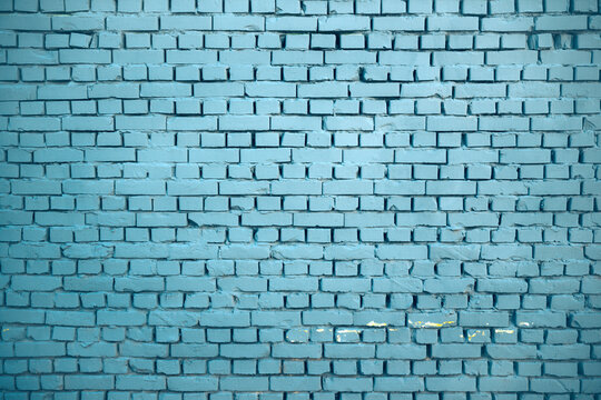 Blue painted brick wall with weathered surfaces, uneven masonry and subtle variations in color and texture. Urban architectural background ,construction, interior design, grunge and abstract concepts.