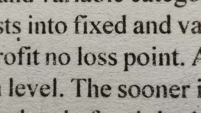 Closeup of loss word printed on news articles, books or magazine pages emphasized and highlighted. Company bankruptcy, investment risk, economic drop, business failure and financial deficit concept.