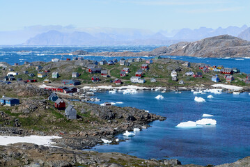 Picturesque, stunning seascape and village with colorful homes in Greenland © ChristyLangPhotos