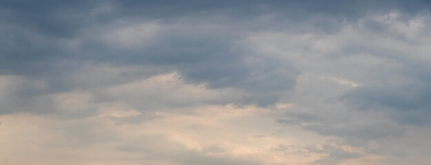 Fototapeta premium Overcast sky with dense gray clouds panoramic view at dawn