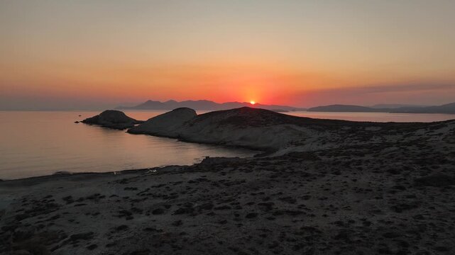 Aerial drone view over Mandrakia village near Sarakiniko beach on the Greek island Milos in Greece during sunrise. Unique rock formations of the coastline. 