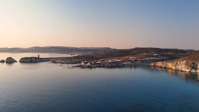 Aerial drone view over Mandrakia village near Sarakiniko beach on the Greek island Milos in Greece during sunrise. Unique rock formations of the coastline. 