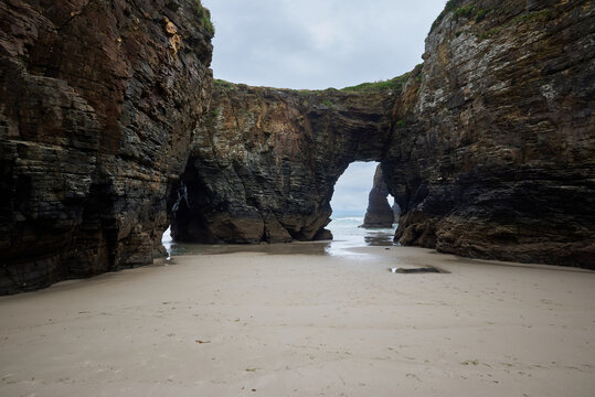 The sea and rocks at Praia das Catedrais, Beach of the Cathedrals in Ribadeo, Galicia Spain cloudy sky